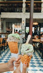 Cropped hands of woman holding ice cream