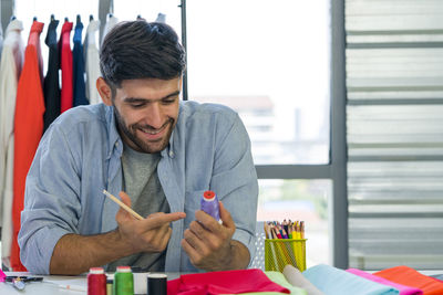 Man looking at camera while sitting on table