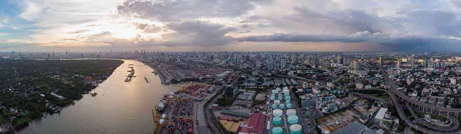 High angle view of city by sea against sky