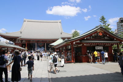 People at temple against sky