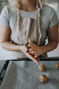 Woman in kitchen preparing cookies