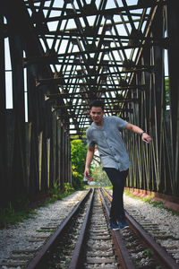 Man standing on railroad track