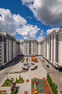 High angle view of street amidst buildings in city against sky