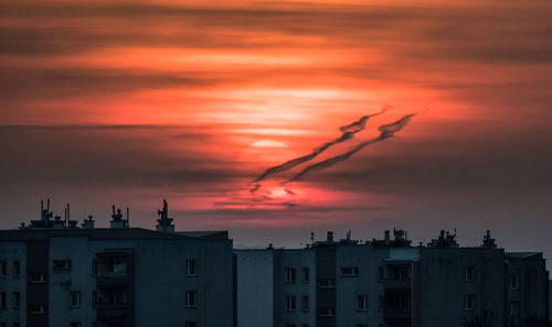 Silhouette buildings against sky during sunset