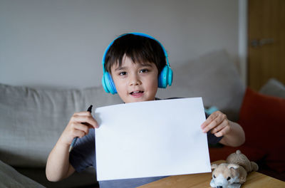 Portrait of young woman using digital tablet at home