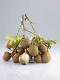 Close-up of fruits on table against white background