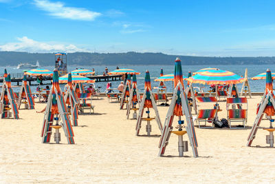 People at beach against sky