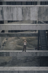 Woman standing on staircase of building