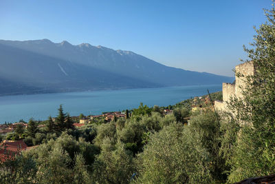 Scenic view of sea and mountains against clear sky