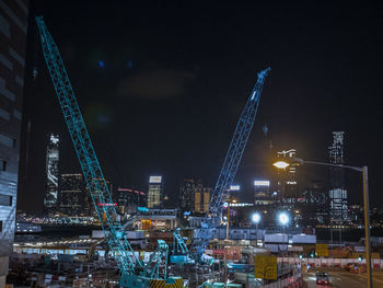 Illuminated cityscape against sky at night