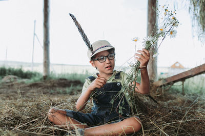 Portrait of man sitting on field