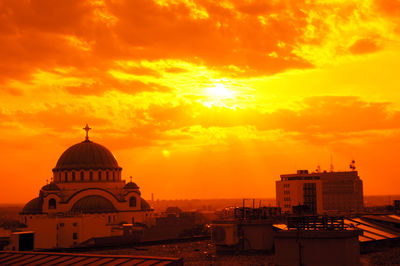 View of buildings against orange sky