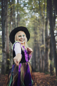 Full length of a smiling halloween girl in forest