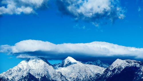 Scenic view of snowcapped mountains against sky