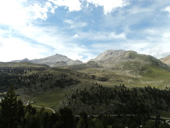 Scenic view of mountains against cloudy sky