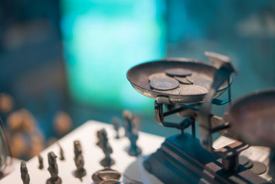 Close-up of currency in weight scale on table