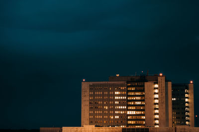 Illuminated building against sky at night