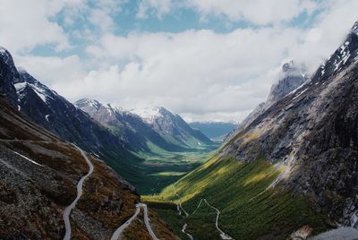 Scenic view of mountains against cloudy sky