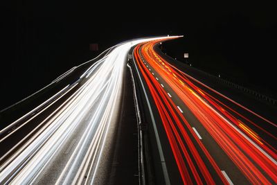 High angle view of light trails on highway at night