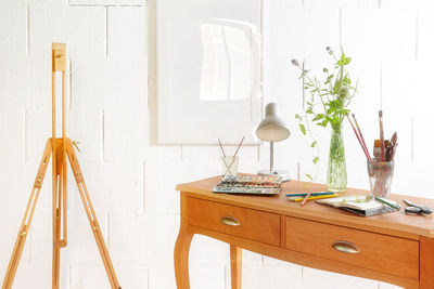 White flowers on table against wall at home