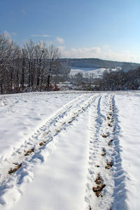 Snow covered field against sky