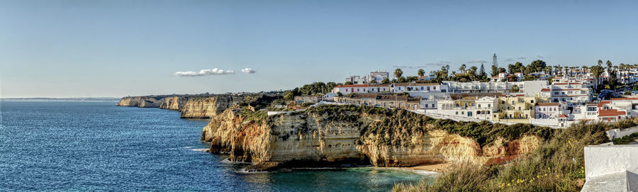 Panoramic view of sea and buildings against sky