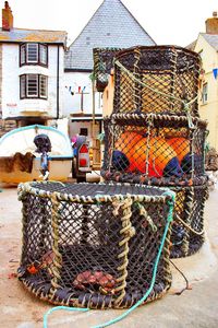 Stack of fishing net on street against buildings