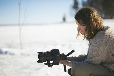 Photographer sitting on snow and relaxing