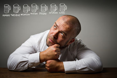 Portrait of a man sitting on table