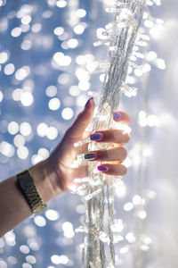 Close-up of hand holding illuminated lighting equipment