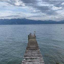 Pier on lake against sky