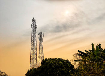 Low angle view of communications tower against sky during sunset