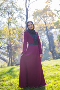 Portrait of woman standing on field