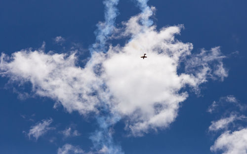 Low angle view of airplane flying in sky airshow