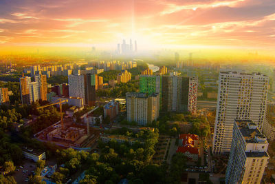 High angle view of modern buildings against sky during sunset