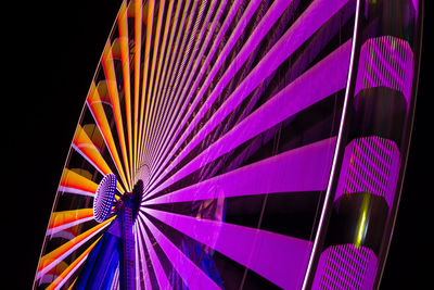 Low angle view of illuminated ferris wheel