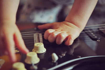 Close-up of hand playing guitar