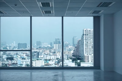 Cityscape against sky seen through window