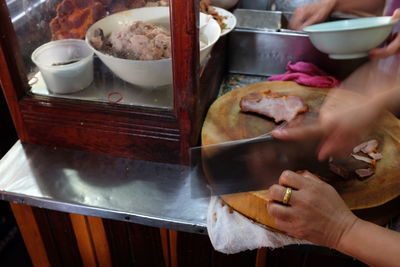 Close-up of person preparing food on table