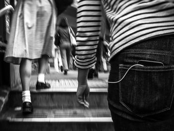 Low section of people walking on floor