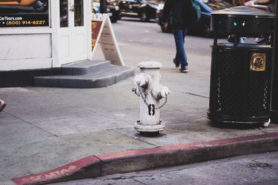 Low section of man on street in city