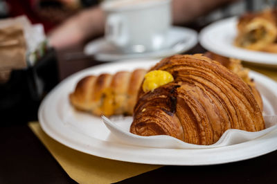 Croissant and sweets on the plate, breakfast in turin, italy