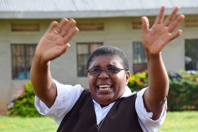 Close-up of senior man dancing on grass field