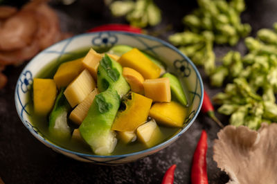 Directly above shot of chopped fruits in bowl on table