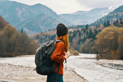 Rear view of man standing on mountain