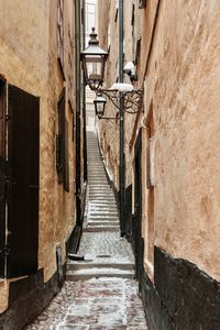 Empty footpath amidst buildings