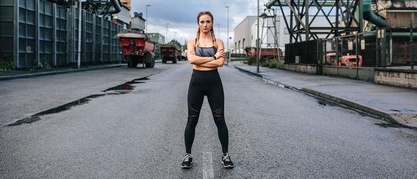 Full length portrait of woman standing in city