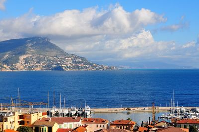 Panoramic view of townscape by sea against sky