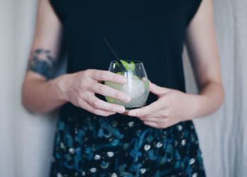 Close-up of hands holding drink