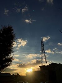 Low angle view of silhouette windmill against sky at night